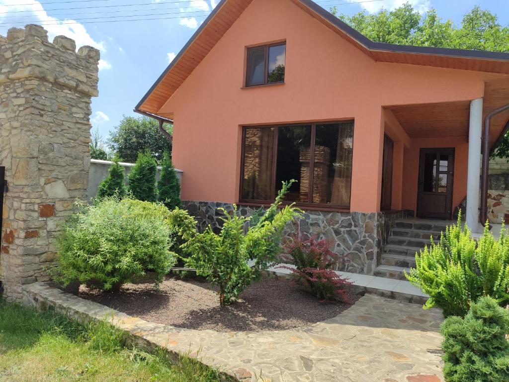 a home with plants in front of it at La Boier in Bălţi