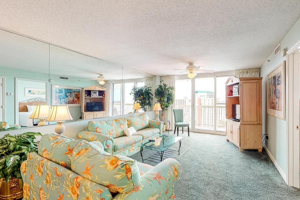 a living room with a couch and a table at Pelican Beach Resort 1717 in Destin