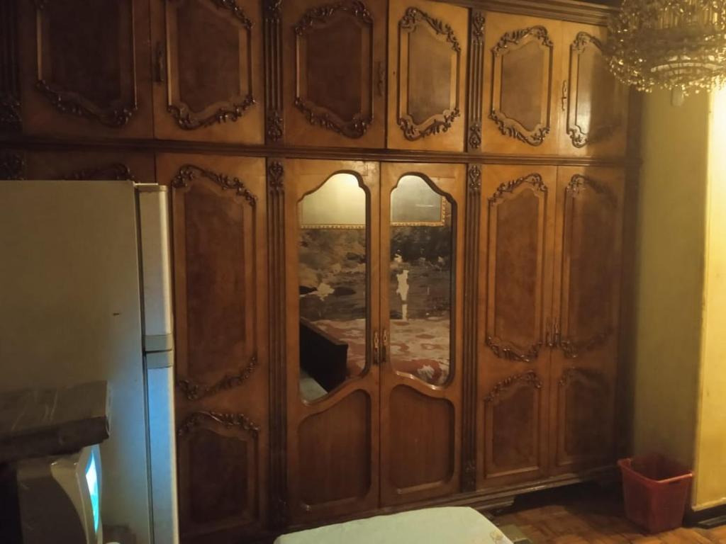a wooden cabinet with a window in a kitchen at فندق جاردن رويال in Cairo