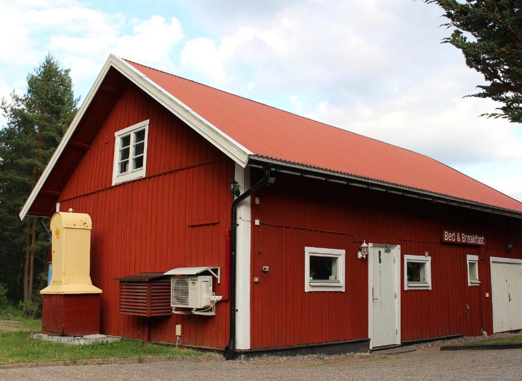 a red barn with a red roof at Twister 53 in Sparreholm