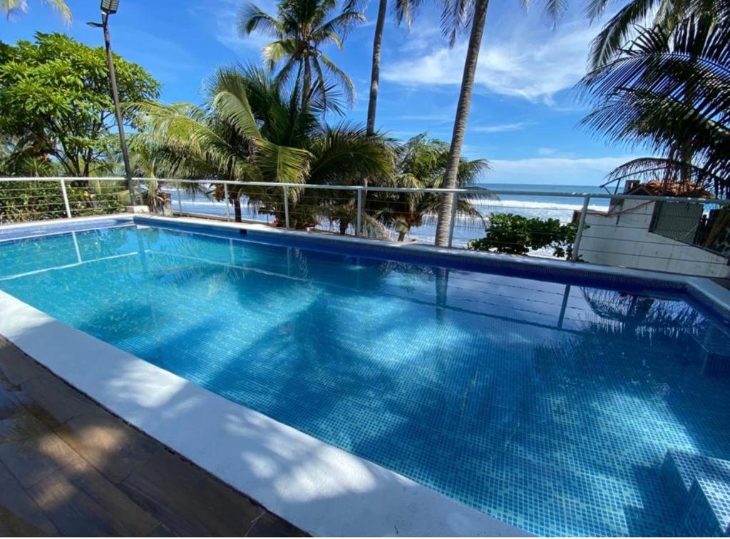 a swimming pool with a view of the ocean at Konchamar in La Libertad