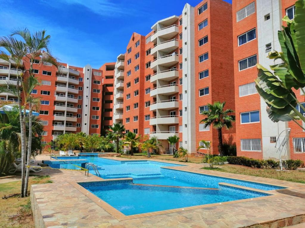 uma imagem de um complexo de apartamentos com duas piscinas em Lo mejor de isla Margarita em Pampatar