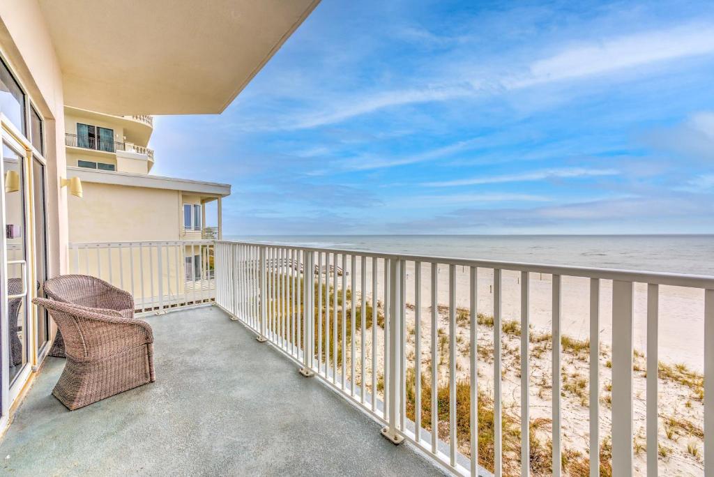 a balcony with a chair and a view of the beach at Windemere 0302 in Perdido Key