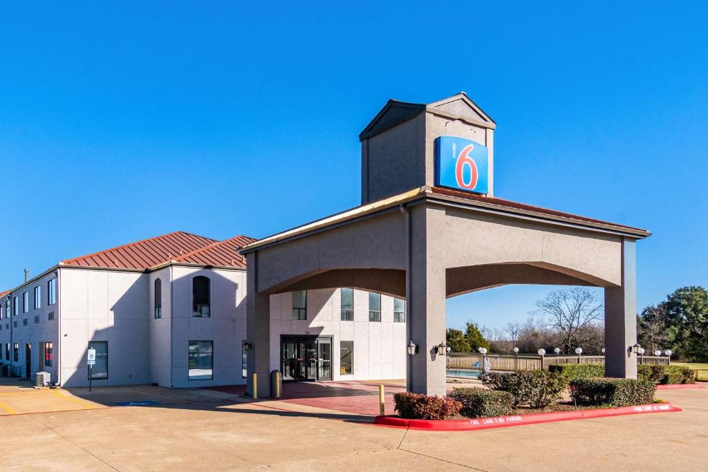 a building with a clock tower on top of it at Motel 6-Ennis, TX in Ennis