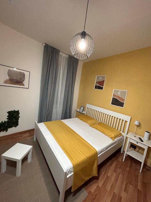 sypialnia z dużym łóżkiem i żółtą ścianą w obiekcie Bonne Nuit Terracina w mieście Terracina