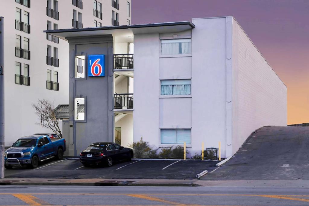a car parked in a parking lot in front of a building at Motel 6 Atlanta, Ga - Midtown in Atlanta