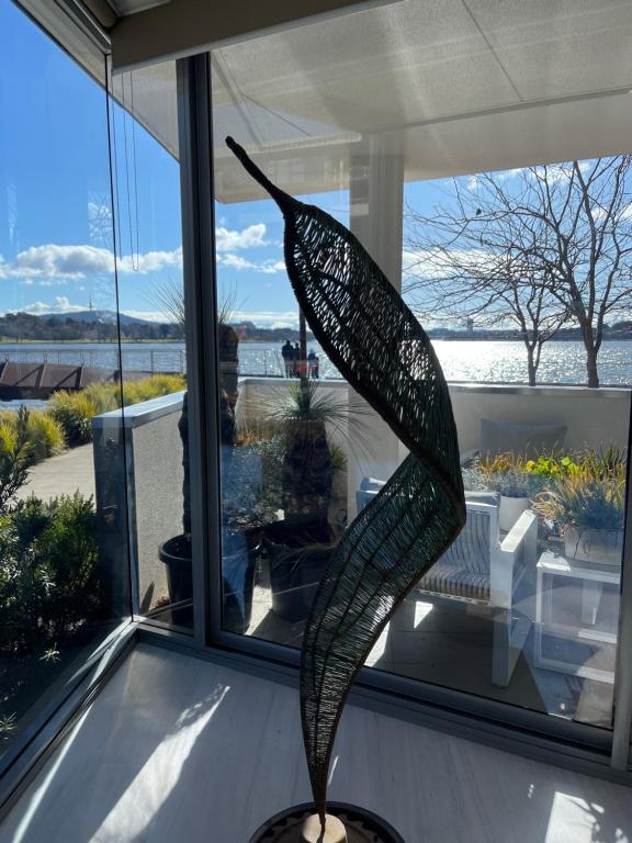 a sculpture of a fish in a room with a window at Lakeview Luxe - EV charger, Pool, Gym, Location + in Kingston 