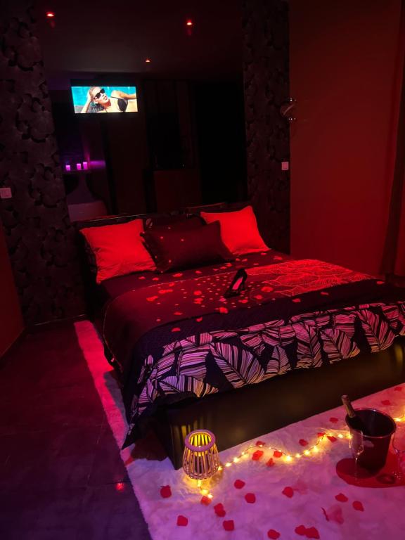 a bedroom with a bed with lights on the floor at HomeSparadise Loveroom in Besançon