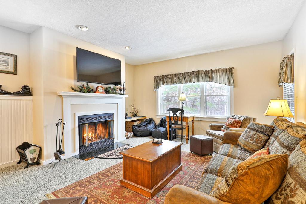 Winterplace Getaway A101 في لودلو: غرفة معيشة مع أريكة ومدفأة