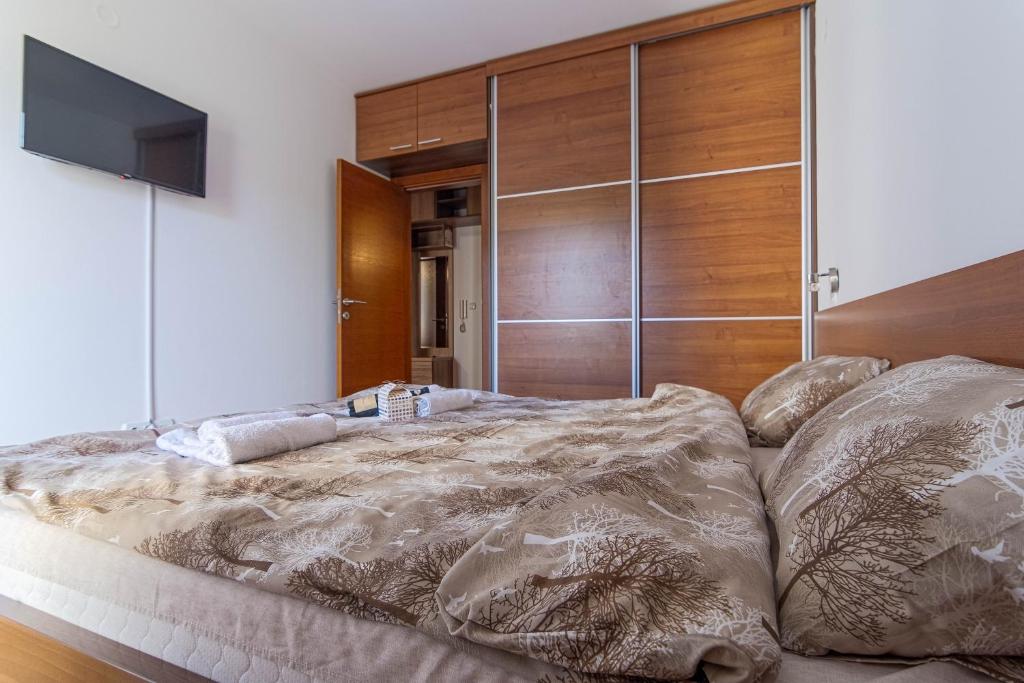 Postel nebo postele na pokoji v ubytování Duma Apartmani Vrnjačka Banja