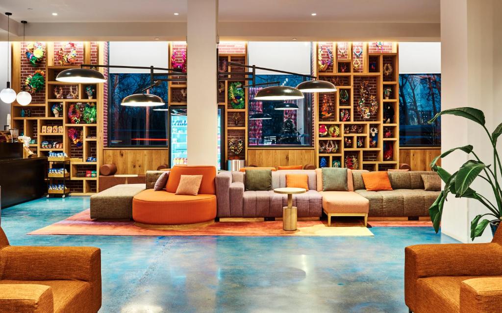 a lobby with couches and chairs and a table at Radio Hotel in New York