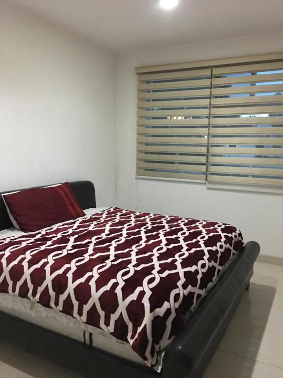 a bedroom with a bed with a brown and white blanket at Residencial Sta Lucía -1 in Yelateni