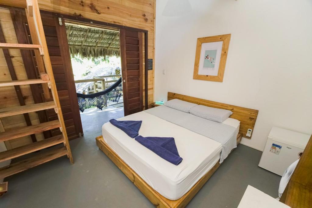 um quarto com uma cama, uma escada e uma janela em Casa Mar Taíba em São Gonçalo do Amarante