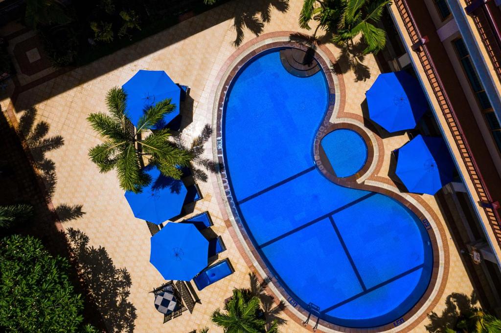an overhead view of a swimming pool with blue tiles at Angkor Holiday Hotel in Siem Reap