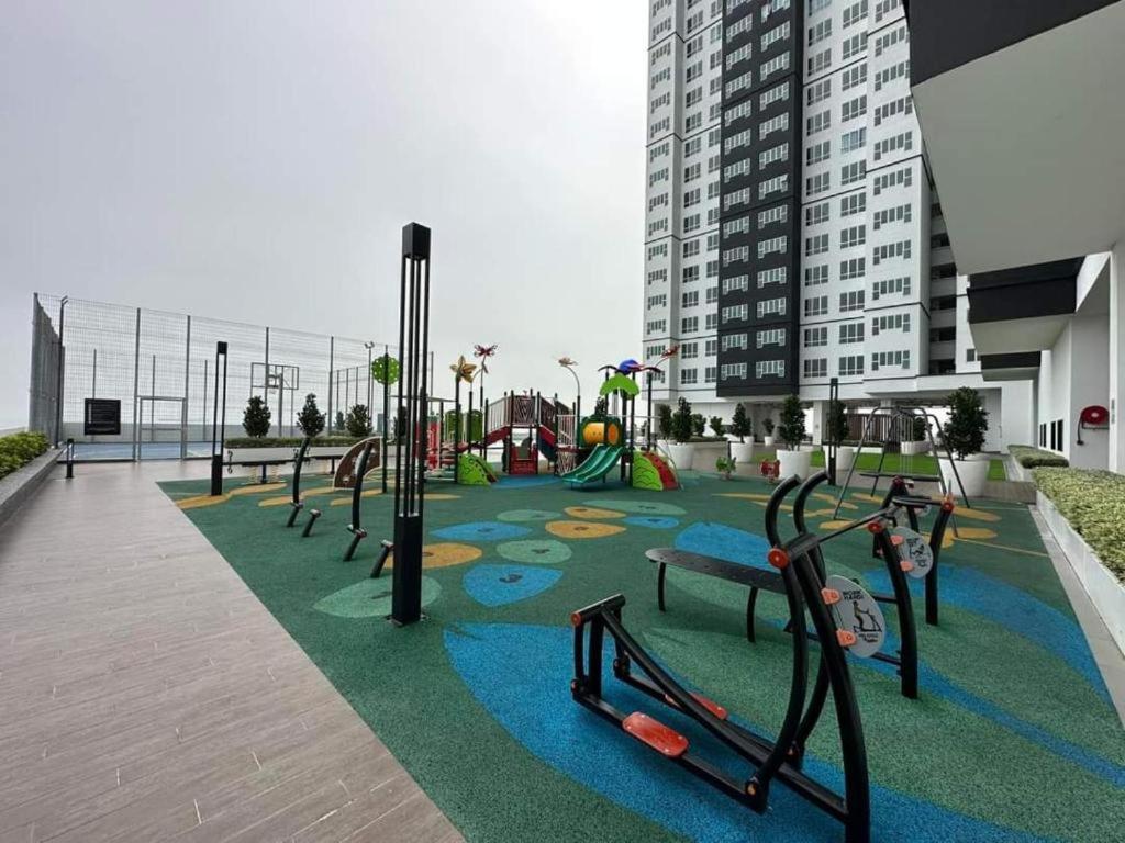 a playground in a building with a park with benches at Amber Cove Leisure Homestay Melaka in Melaka