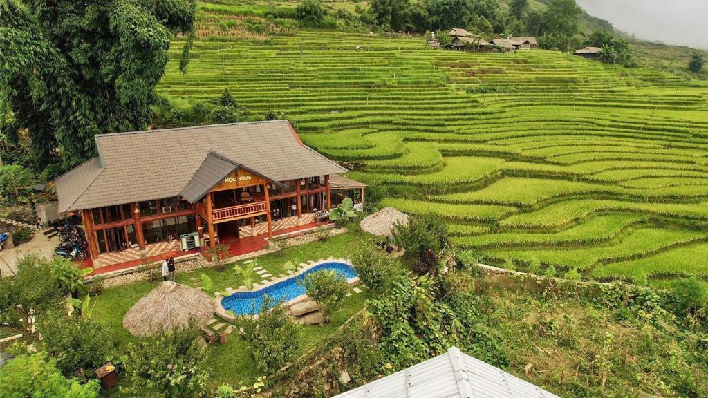 an aerial view of a house next to a field at Moc Home Sapa in Sa Pa