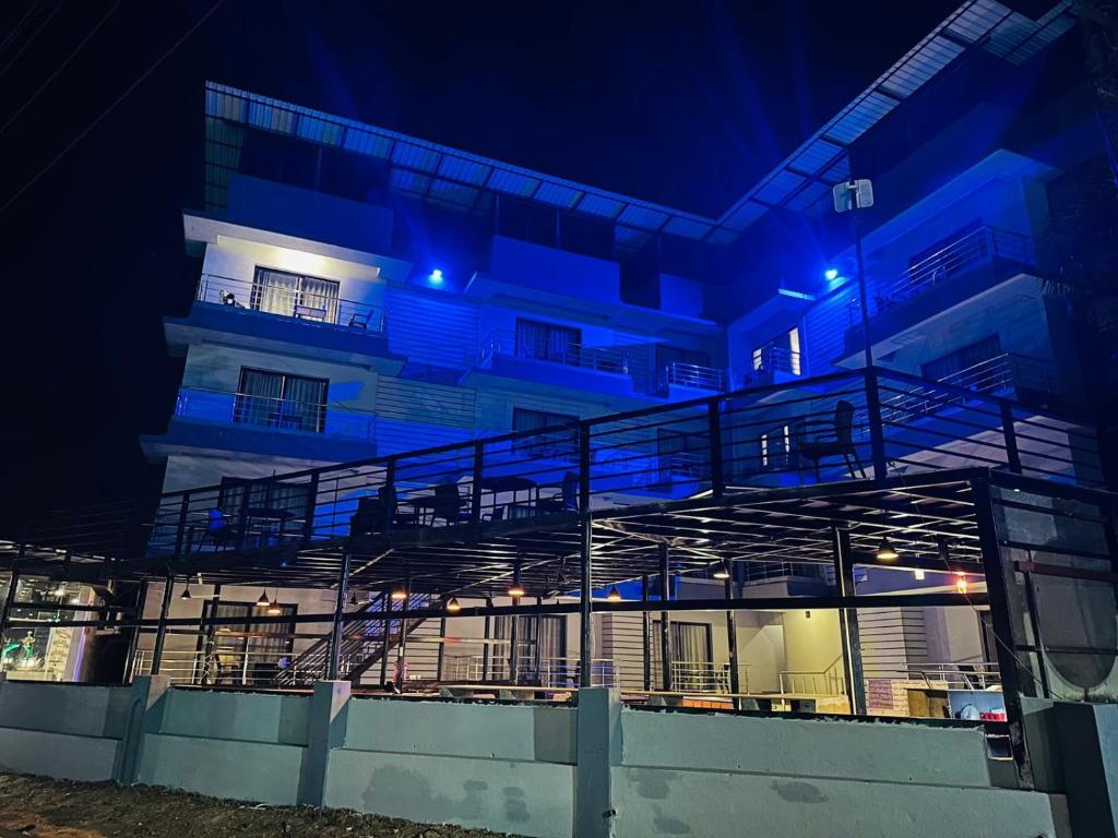 a building with blue lights on it at night at JW HERITAGE in Anjuna