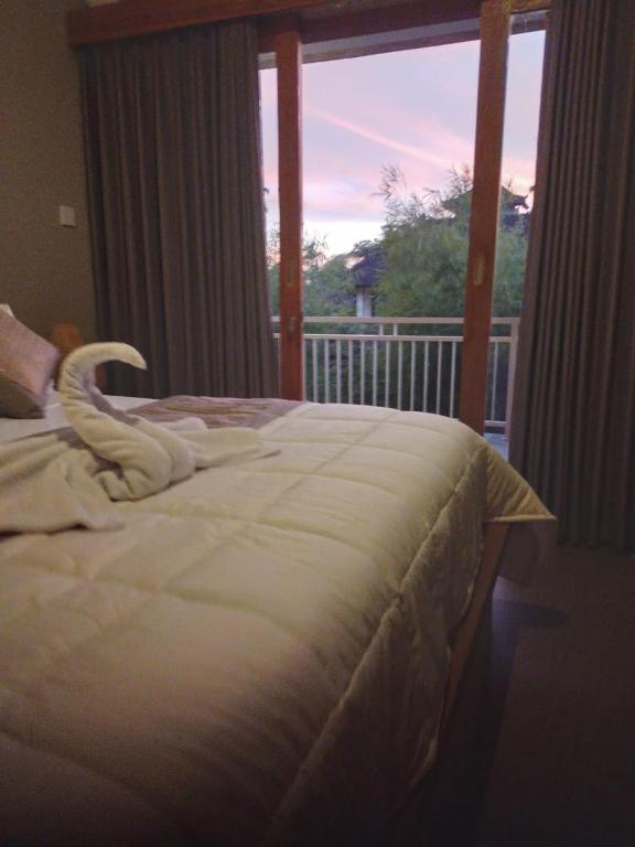 Postel nebo postele na pokoji v ubytování Kasapa Inn