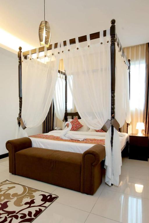 Postel nebo postele na pokoji v ubytování Ipoh Downtown Hotel