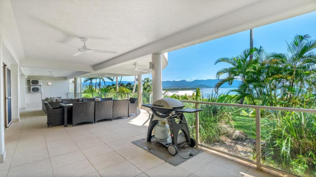 an open living room with a view of the ocean at Island Point Villa 1 Port Douglas in Port Douglas