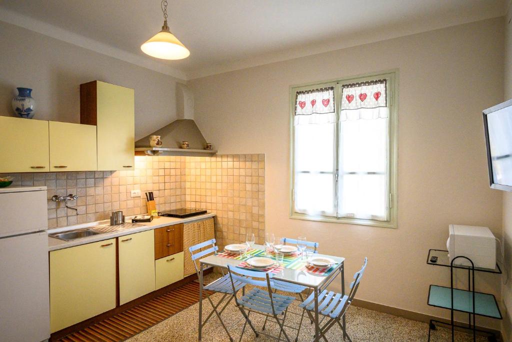 a kitchen with a table and chairs in a room at Casa stella in San Lorenzo al Mare