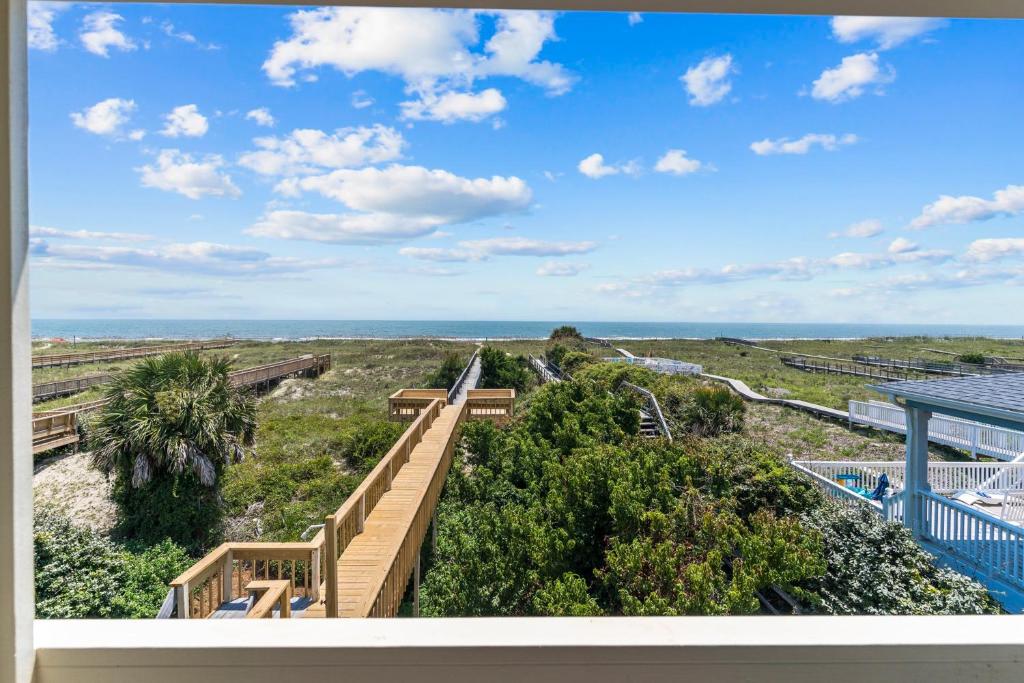 a view of the ocean from the balcony of a house at Bayview East & West in Holden Beach