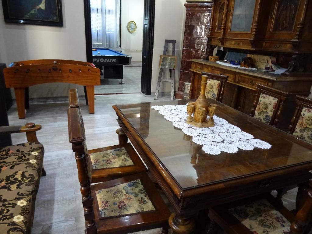 uma sala de estar com uma mesa de madeira e cadeiras em Mia Casa em Novi Sad