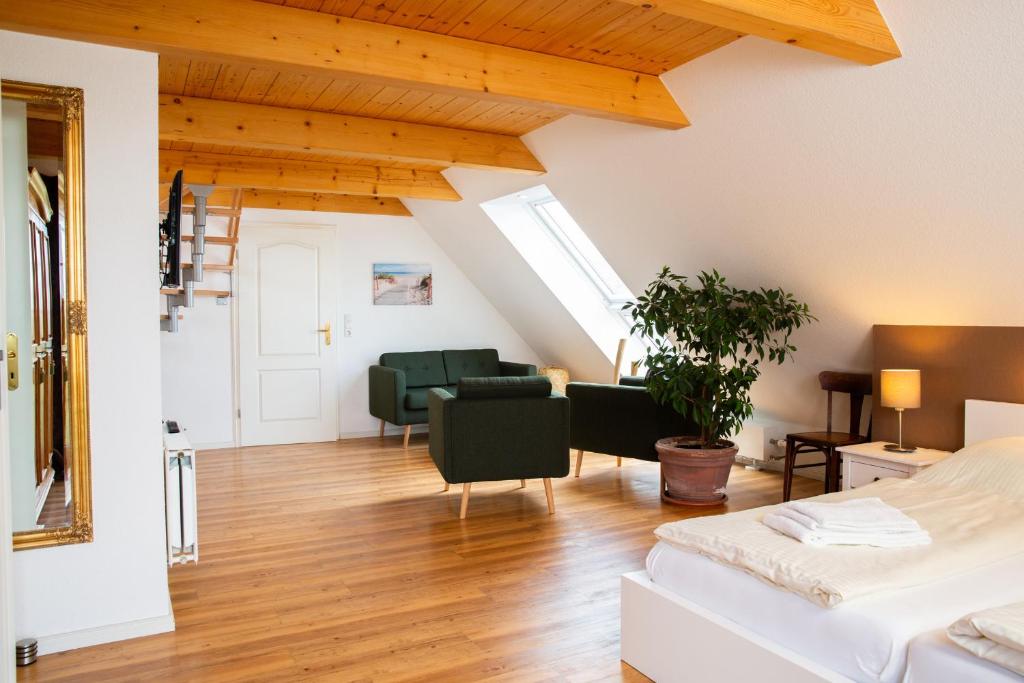 a bedroom with a bed and a living room at Haus im Felde Whg 6 in Fehmarn