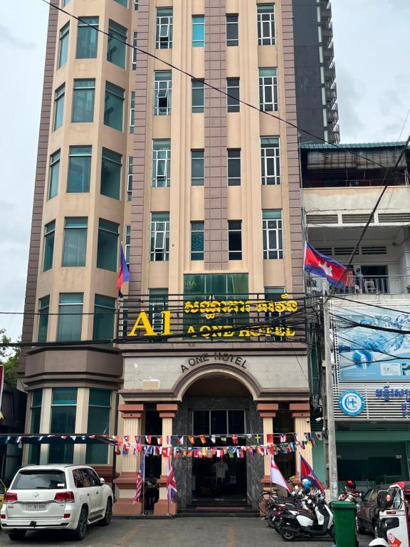 un gran edificio con un cartel delante en A1 Hotel, en Phnom Penh