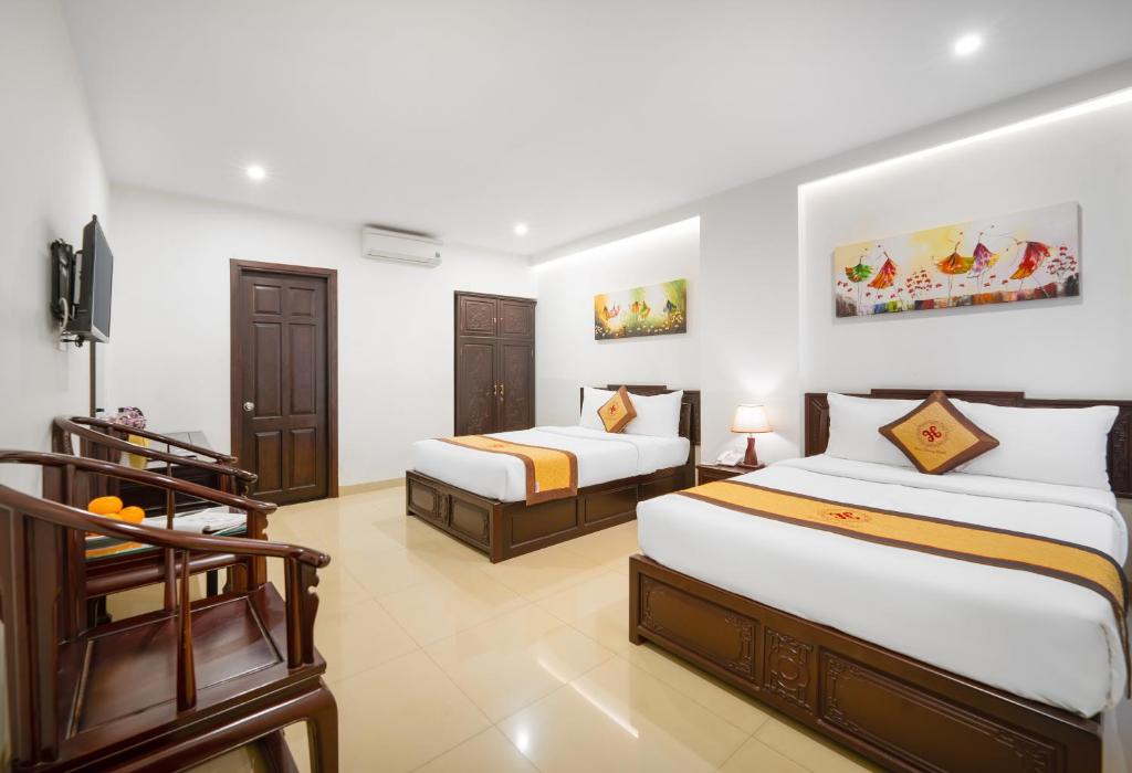 Giường trong phòng chung tại Hoa Phong Airport Danang Hotel