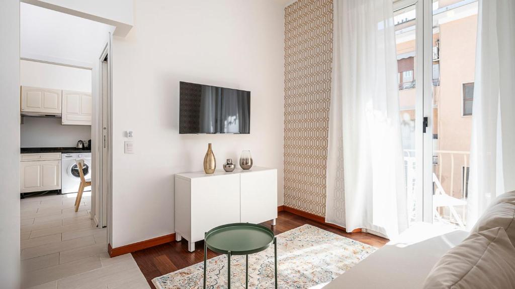 a living room with a white cabinet and a tv at "Gold Fashion" - Residenza DUOMO Citylife in Milan