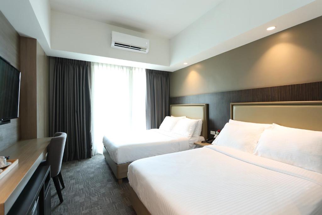 Postel nebo postele na pokoji v ubytování Sotogrande Hotel Katipunan