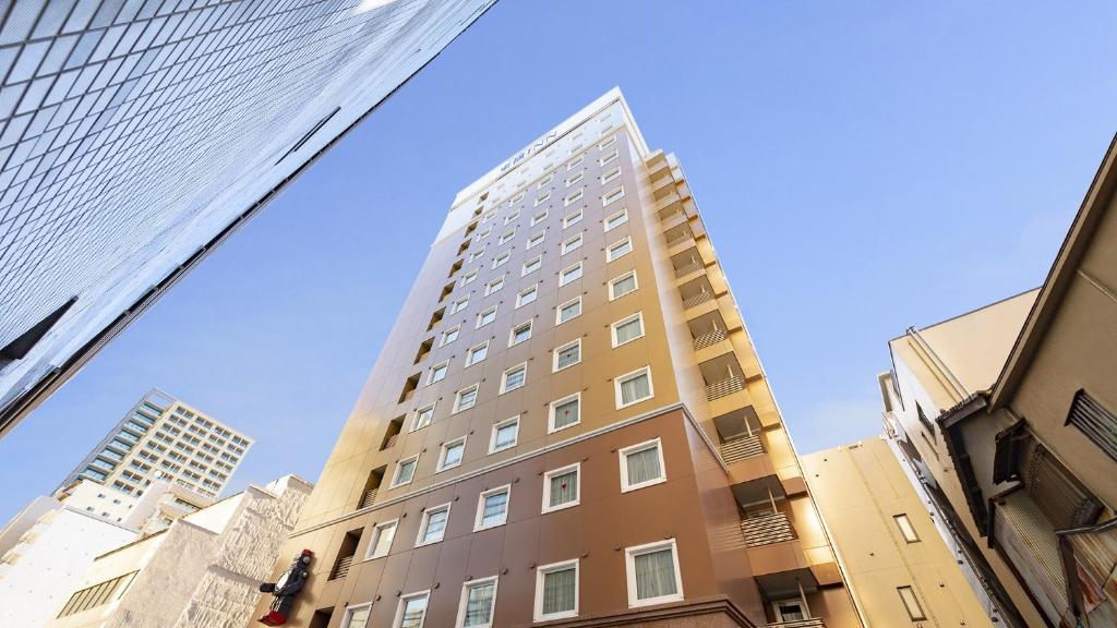 a tall building in the middle of some buildings at Toyoko Inn Tokyo Asakusa Kuramae No.2 in Tokyo