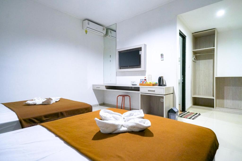 Postel nebo postele na pokoji v ubytování Urbanview Pecatu Residence Bali by RedDoorz