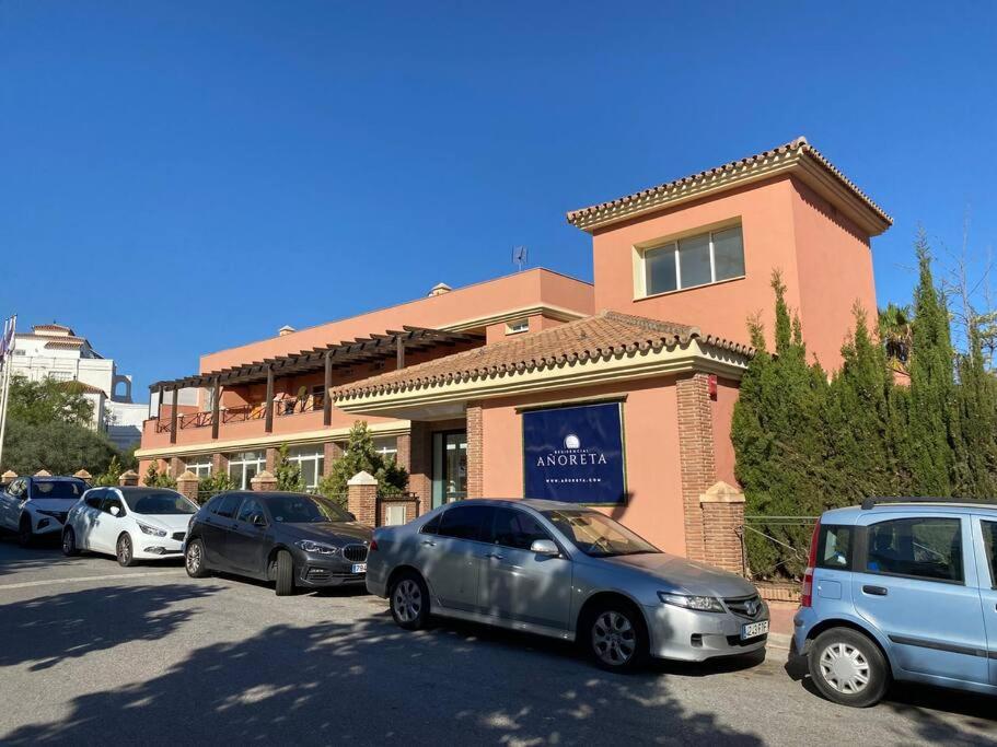 a group of cars parked in front of a building at Costa del Golf in Torre de Benagalbón