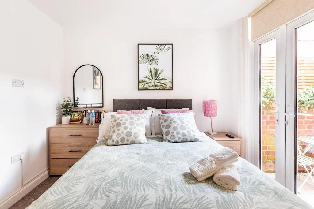 a white bedroom with a large bed and a mirror at Northumberland Boutique Guest House #2 in Coventry