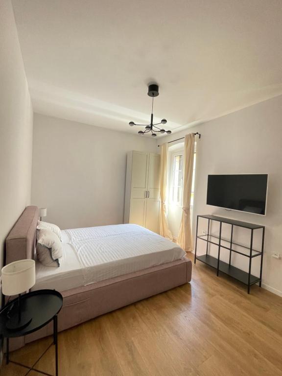a bedroom with a bed and a flat screen tv at Zadar Relax Apartment in Zadar