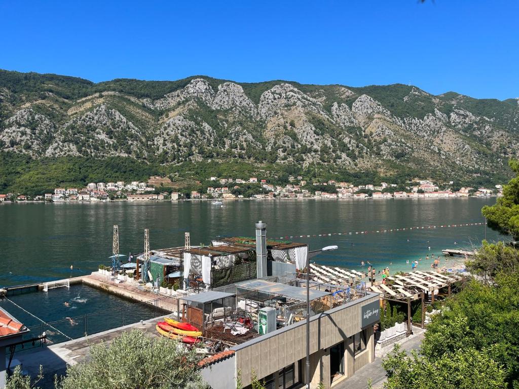 a marina with a dock and mountains in the background at Sea Breeze in Kotor