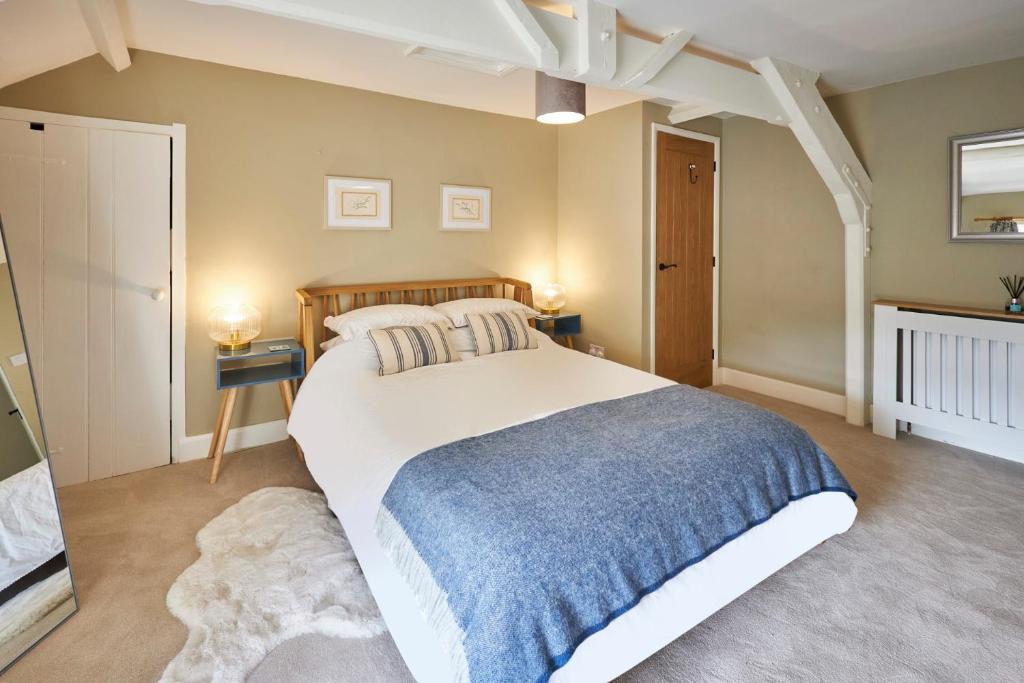 a bedroom with a large white bed and two lamps at Host & Stay - North Cottage in Newbrough