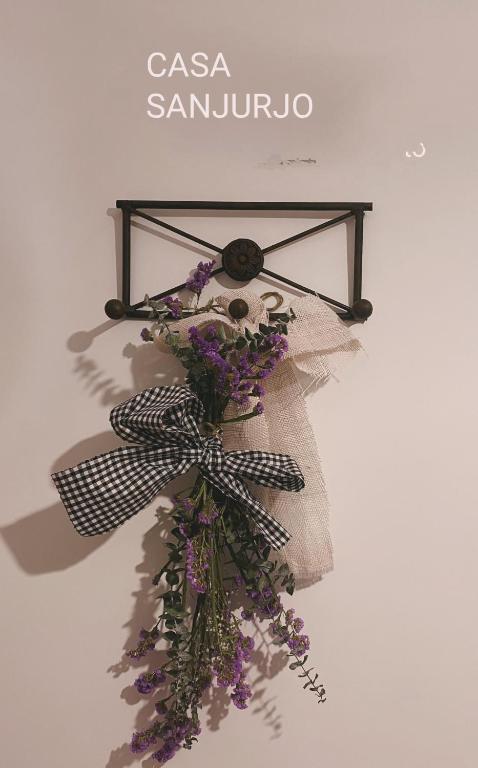 a bunch of flowers hanging on a wall at Casa Sanjurjo in Monforte de Lemos