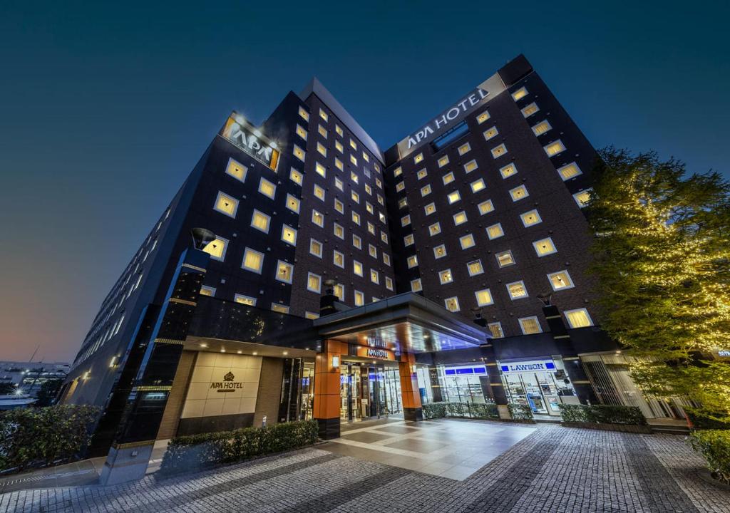 a hotel with two tall buildings at night at APA Hotel & Resort Tokyo Bay Shiomi in Tokyo