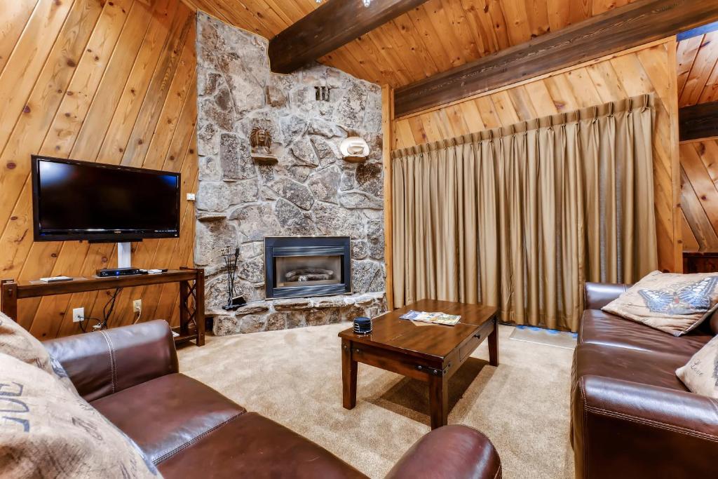 a living room with a couch and a fireplace at Phoenix 110 in Steamboat Springs