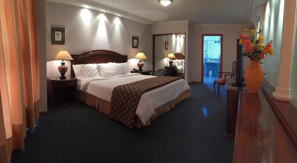 a hotel room with a large bed in a room at Crystal Palace Hotel in Montevideo