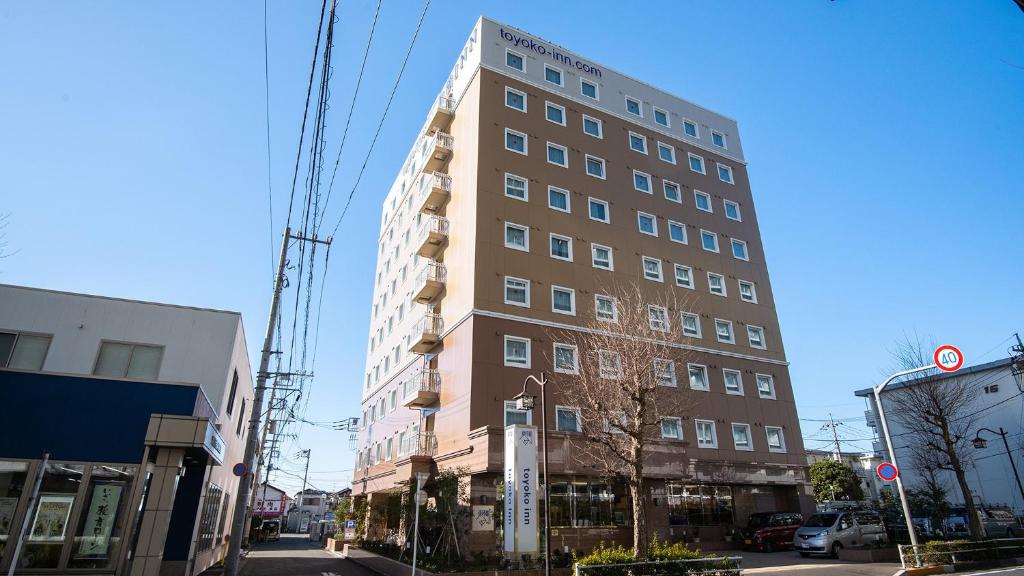 a tall building on the side of a street at Toyoko Inn Tokyo Akishima-eki Minami-guchi in Akishima