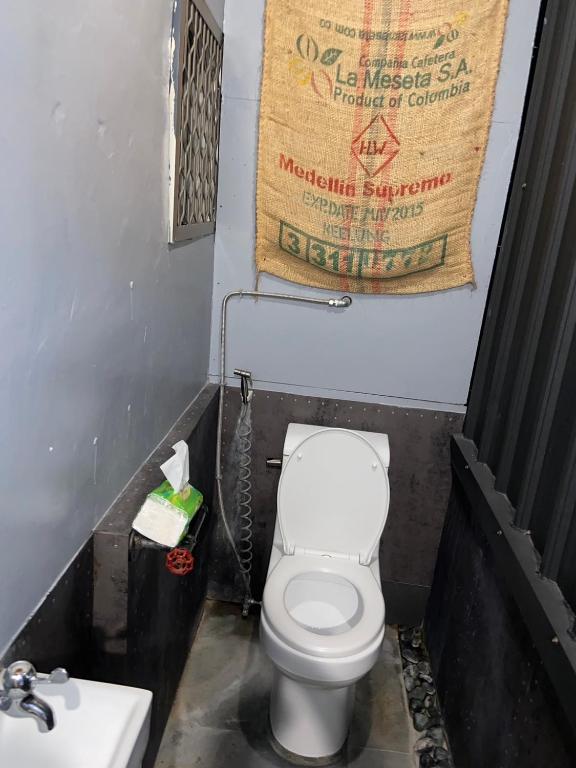 a small bathroom with a toilet and a sink at Hive Bed and Backpacker蜂巢膠囊旅店 in Hualien City