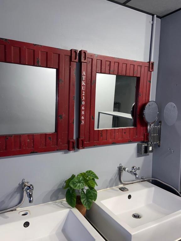 a bathroom with two sinks and a mirror at Hive Bed and Backpacker蜂巢膠囊旅店 in Hualien City
