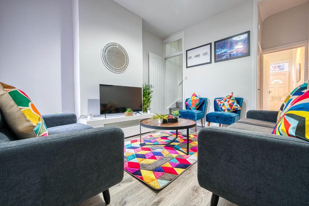 a living room with two couches and a table at K Suites - Madeley Road in Birmingham