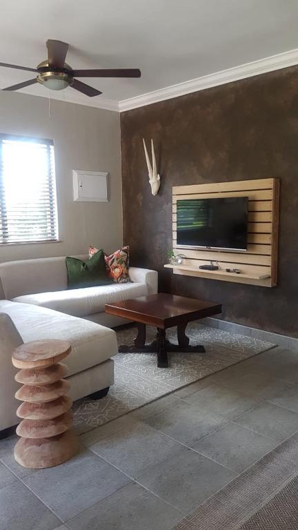 a living room with a couch and a coffee table at Bannockburn Guest Cottage in White River