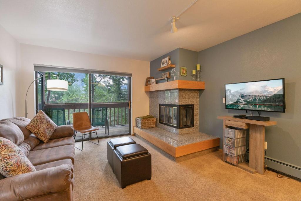 a living room with a couch and a fireplace at Lagoon Royal Townhome: Mountain Views Meet Modern Comforts in Frisco