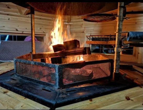 a large iron grill with fire coming out of it at Moon Valley Glamping 